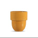 A small yellow-orange ceramic cup with a ribbed flared rim and a rounded base, centered on a plain white background.