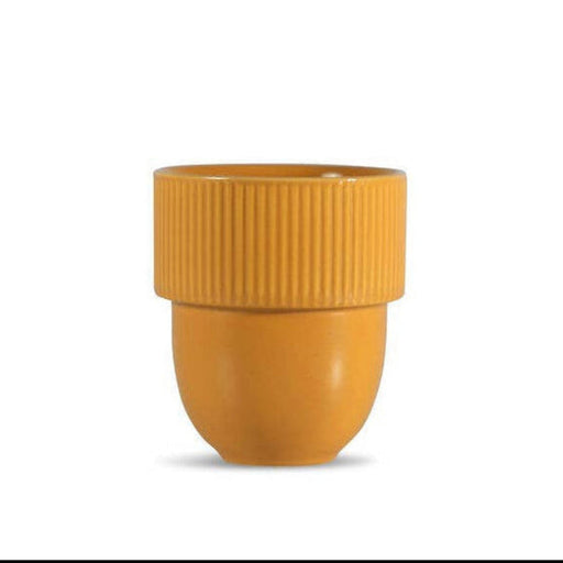 A small yellow-orange ceramic cup with a ribbed flared rim and a rounded base, centered on a plain white background.
