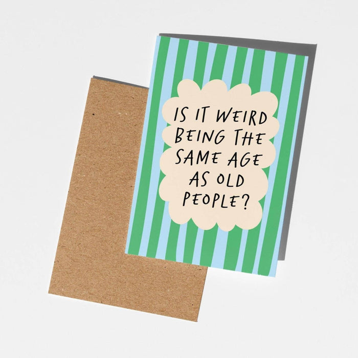 Card with humorous text on a striped background, placed on a plain surface