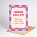 Greeting card with pink and blue checkered border and text 'Sending you love because wow what A shit show' on a white background.
