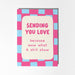 Card with pink and blue checkered border and text 'Sending you love because wow what a shit show' on a white background