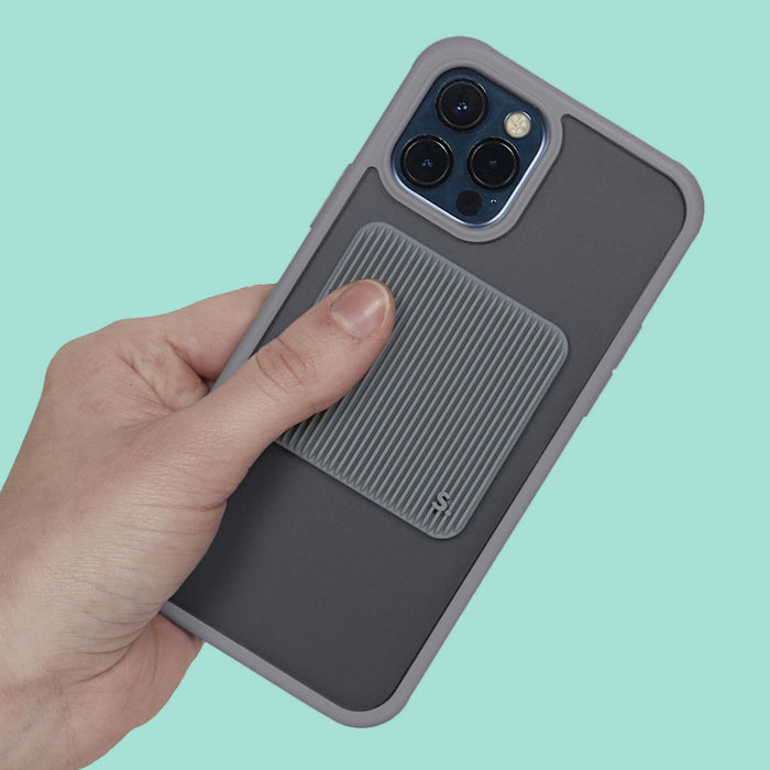 Hand holding a phone with a gray case against a teal background