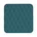 A square teal silicone mat with rounded corners, featuring a textured honeycomb pattern and a small embossed 'S.' logo in the bottom right corner, shown on a plain white background.