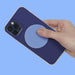 Hand holding a blue phone case with a textured circular design on a blue background