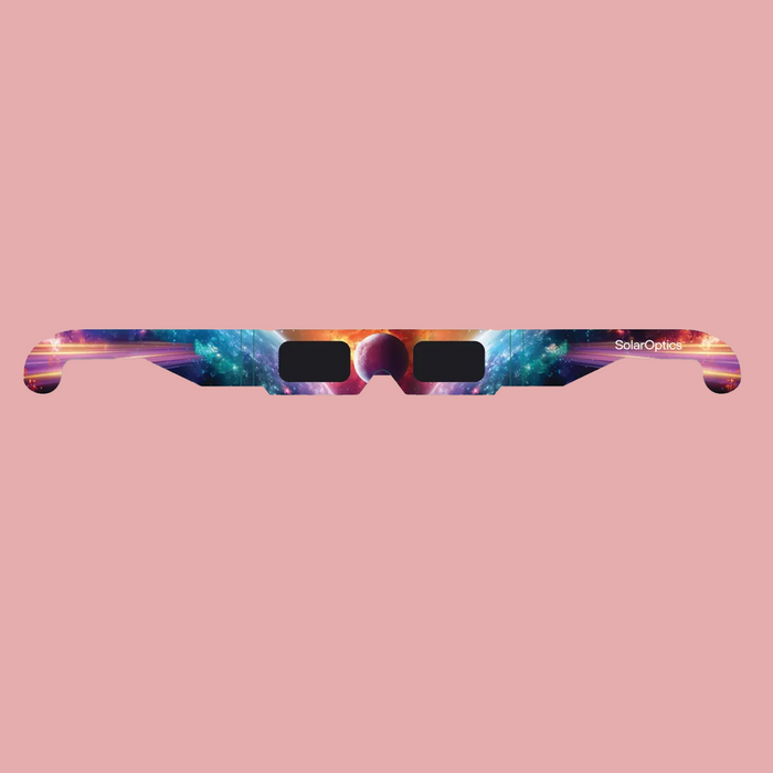Eclipse glasses with a colorful galaxy space print on the arms, featuring black lenses, shown against a solid pink background. The brand name 'SolarOptics' is visible on the right arm.