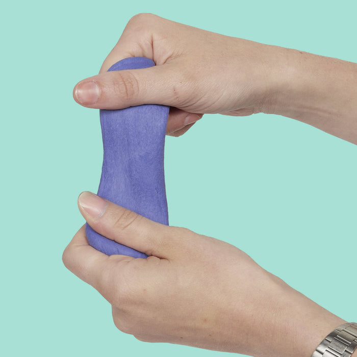Hand holding a purple putty against a teal background