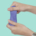 Hand holding a purple putty against a teal background