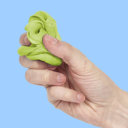 Hand holding green slime against a blue background