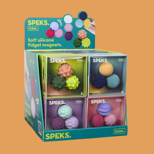 A retail display box of SPEKS. Odds Soft Silicone Fidget Magnets, showcasing four compartments filled with various textured, spherical fidget magnets in multiple colors, set against a solid orange background.