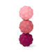 Three stacked raspberry-shaped silicone teething toys in light pink, medium pink, and dark magenta, arranged vertically on a clean white background.