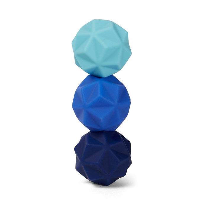 Stack of three geometrically shaped blue and green objects on a white background