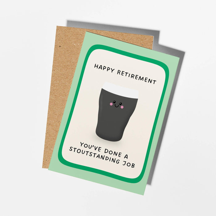A retirement-themed greeting card with a light green border and a cartoon cat illustration, shown with a brown kraft envelope on a clean white background.