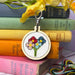 floral design in emboridery hoop displayed in front of colourful books