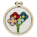 Embroidery hoop with colorful floral design on a white background