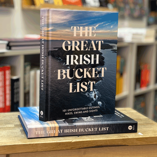 book titled 'the great irish bucket list' on top of a wooden stool in front of a blurred background