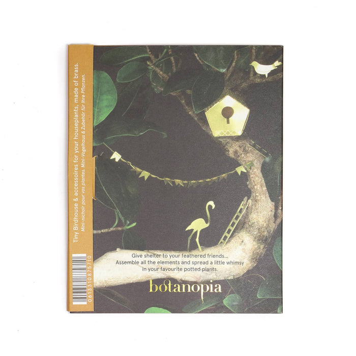 Packaing with nature-themed design featuring plants, a birdhouse, and a flamingo, with 'botanopia' branding.