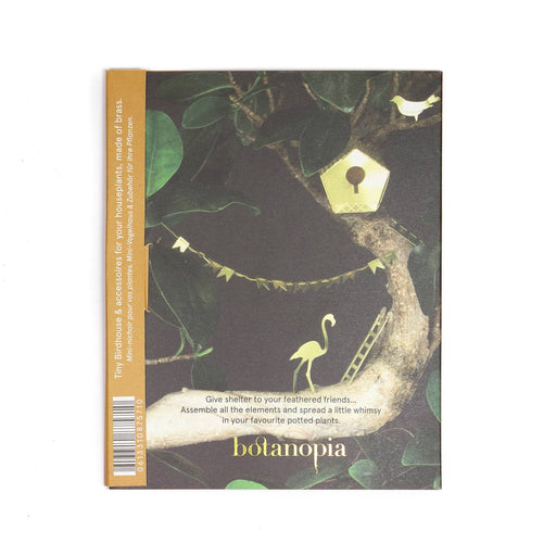 Packaing with nature-themed design featuring plants, a birdhouse, and a flamingo, with 'botanopia' branding.