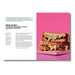 A printed recipe card or magazine page featuring a photo of a sliced black and blue clamshell pudding cake with chocolate sauce on a bright pink plate, alongside recipe text on a white page.
