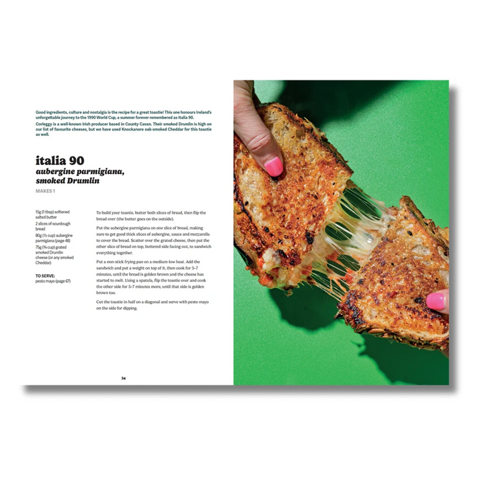 An open magazine or book spread showing a recipe article about Italia 90 amburne parigiana, smoked Drumis. The left page has black text on a white background, and the right page features a bright green background with a close-up photo of a hand holding a piece of grilled fish with melted mozzarella.
