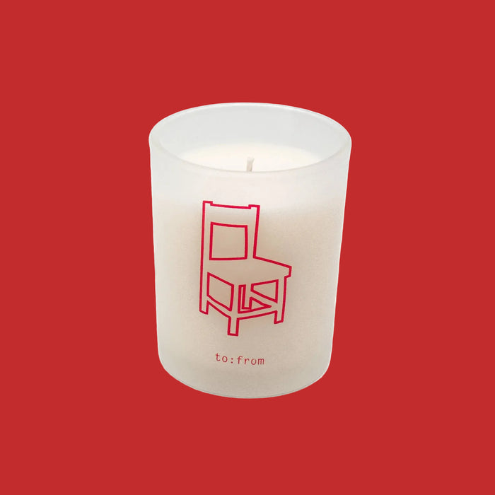 White candle with a red chair design and 'to:from' text on a white background