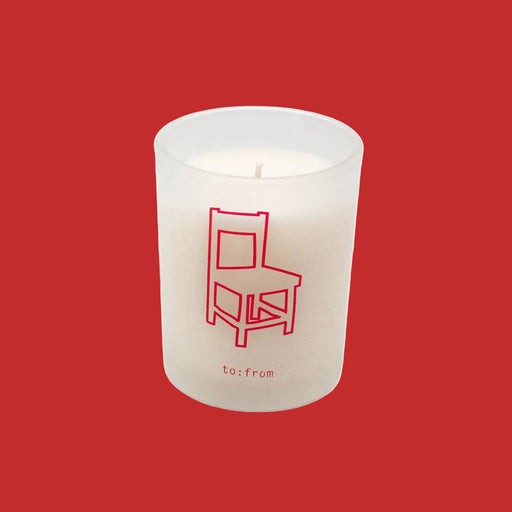 White candle with a red chair design and 'to:from' text on a white background
