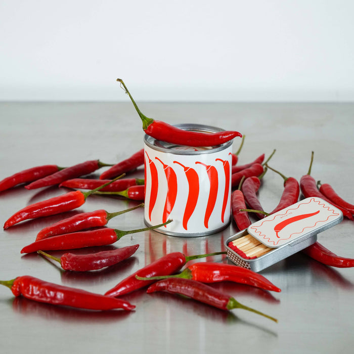 Canned food with red chili peppers on a gray surface