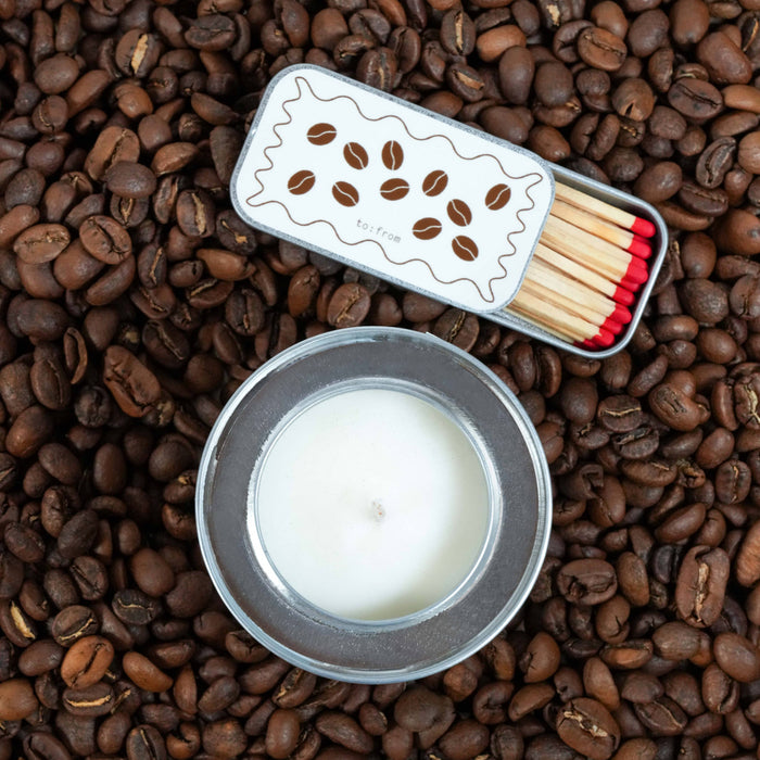Matches and candle on a bed of coffee beans