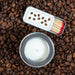 Matches and candle on a bed of coffee beans