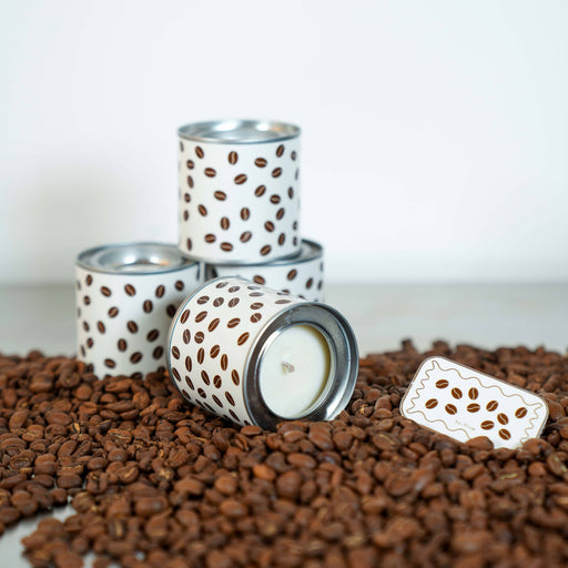 Candle holders with coffee bean design on a bed of coffee beans