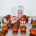 Tomatoes and cans with red and white labels on a reflective surface