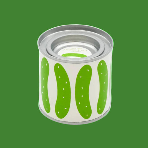 Cylindrical tin candle container with green pickle design on a white background