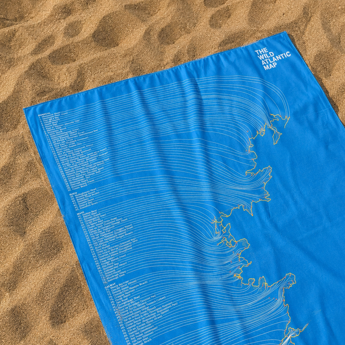 Blue map towel on sand