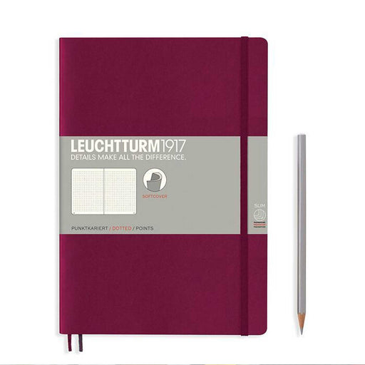 Port Red B5 notebook with grey paper band surrounding it, port red elastic strap and silver pencil to right