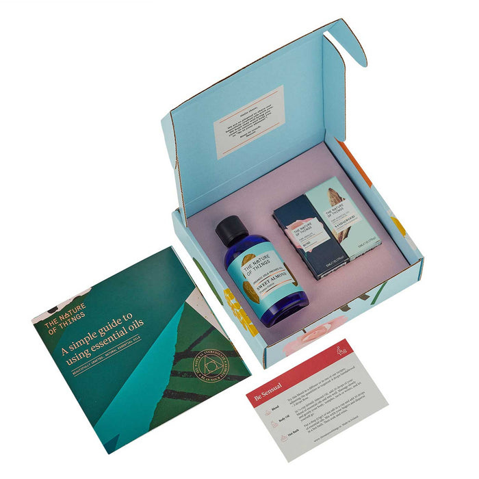 blue gift box with blue bottle and two essential oil product boxes inside, to left is a green and blue booklet and below a information card