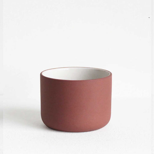 terracotta ceramic mug with white interior and no handle