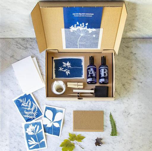 open cyanotype kit box showing what's included in front of a marble background/ 