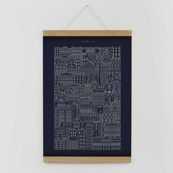 Blue poster with white illustration of city buildings titled Dublin in wooden frame hanging on wall