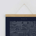 close up of Dublin Blueprint poster, blue poster with white line illustration of city buildings hanging by string to wall