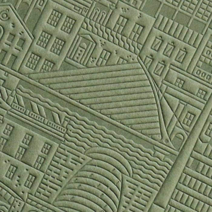 close up of green debossed image of a city bridge with buildings and water