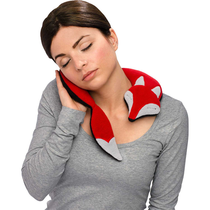 brown haired woman in grey top with eyes closed, holding a red fox shaped neck pillow to her cheeck