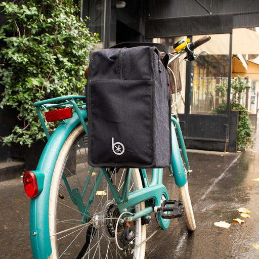 black square bike bag attached to a blue bike with two red rear lights