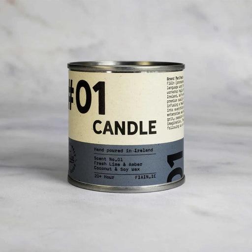 round metal tin with white and blue label with 01 candle in black text, against a grey backdrop