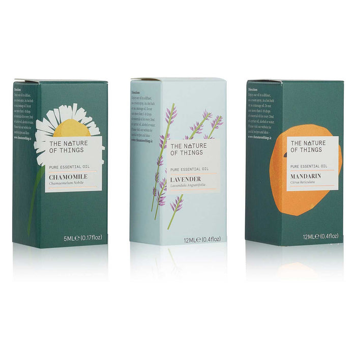 3 essential oil boxes. To left Chamomile, green box with daisy. In middle Lavender box, pale blue with purple flower, to right Mandarin box, green with orange on cover 