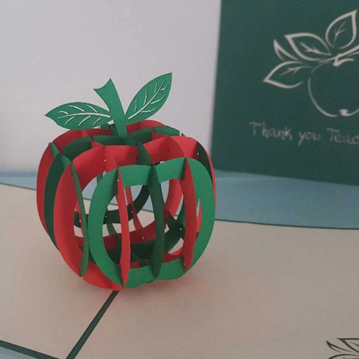 3D paper model of a anpple made of red and green segments with green stalk and two green leaves