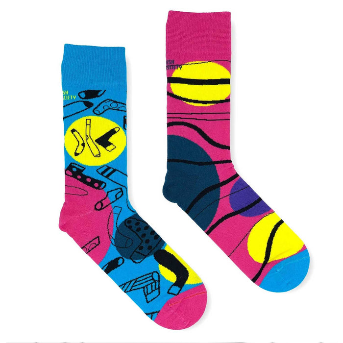 one pink and one blue sock each with yellow, blue and pink circles