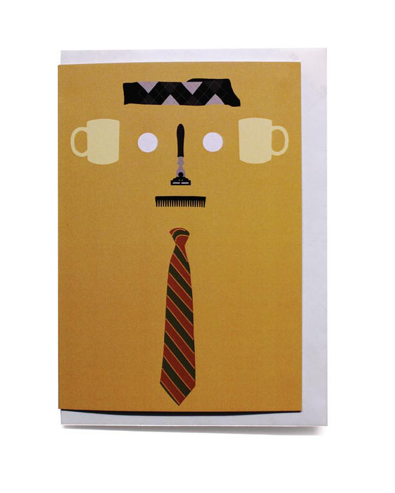 fathers day card with white envelope on white background. yellow card with socks, razor, com ad two mugs arranged to make a face