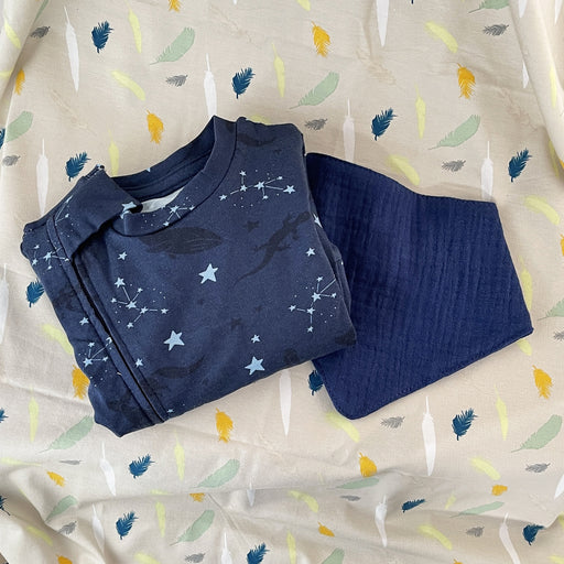 stork and co. baby bundle. navy baby grow with stars and animals on it, navy bib and grey blanket with feathers