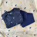 stork and co. baby bundle. navy baby grow with stars and animals on it, navy bib and grey blanket with feathers
