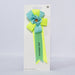 blue and yellow rosette with birthday boy written on it, on off white background
