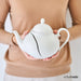 broken tea pot being held by woman